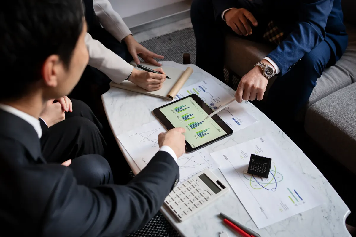 Colleagues planning work together on a tablet